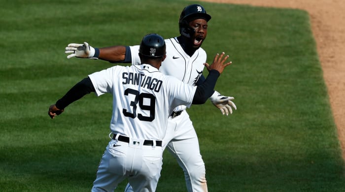 Apr 6, 2021; Detroit, Michigan, USA; Detroit Tigers center fielder Akil Baddoo (60) celebrates with first base coach Ramon Santiago (39) after hitting a walk off single to win the game in the tenth inning against the Minnesota Twins at Comerica Park.